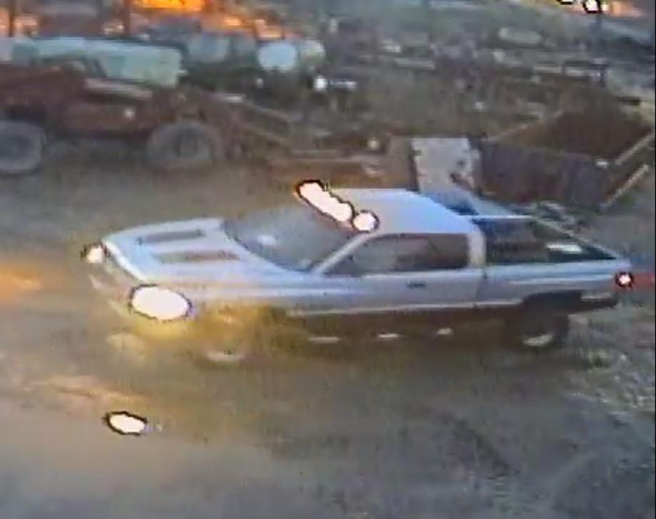 Suspect Vehicle - silver and maroon truck with headlights and overhead lights on
