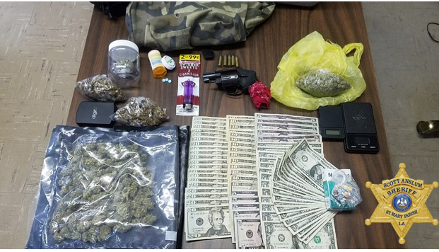 Table full of recovered narcotics and money arranged on a table.