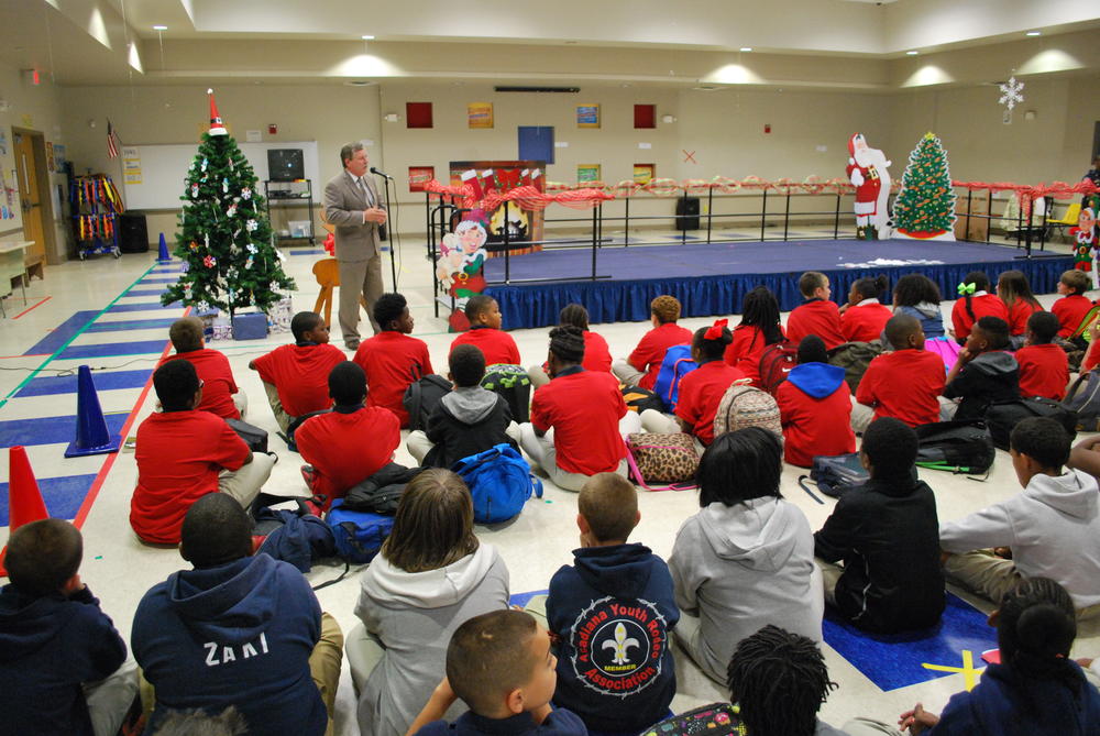 District Judge Lewis Pitman speaking to young students