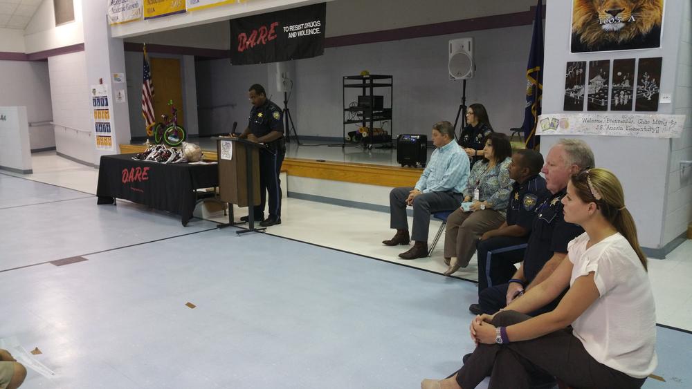 Lt. Alexander Barnes at J.S. Aucoin Elem at a podium