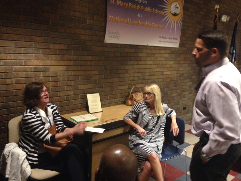 Woman speaking to three others