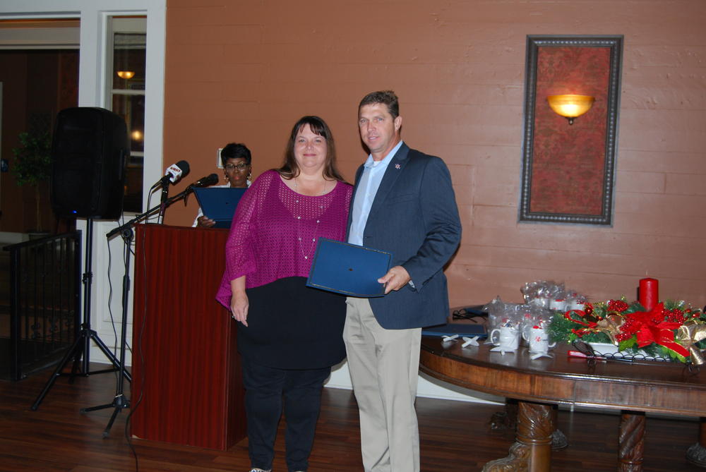 Scott Anslum holding award standing next to a woman