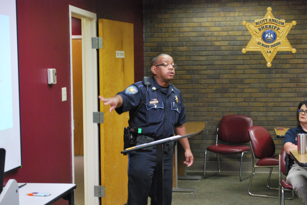 Man in uniform pointing at the projector board