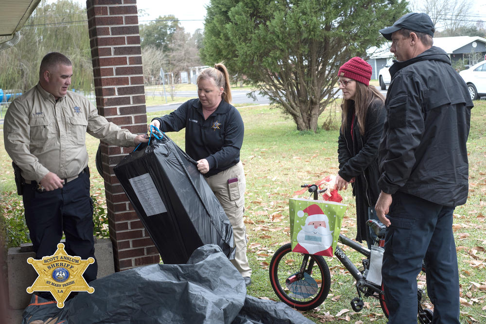 Officers staging gifts on a porch.