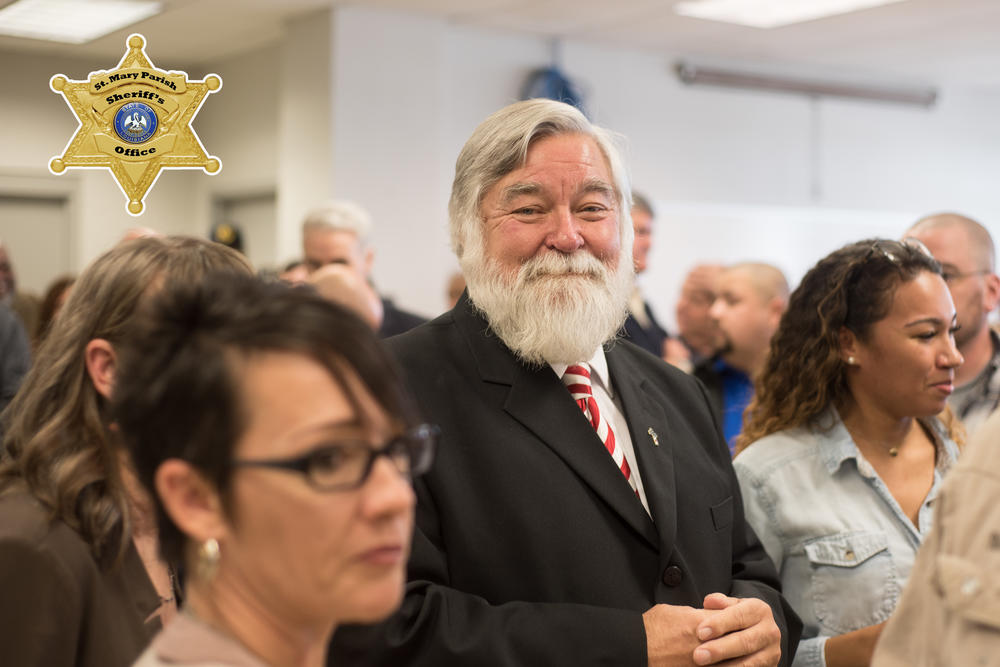 Sheriff Blaise Smith in a suit smiling at the camera in a crowd