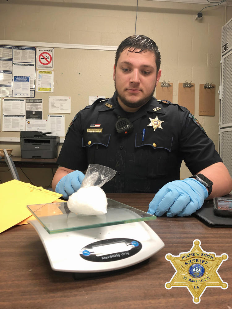 Deputy weighing drugs