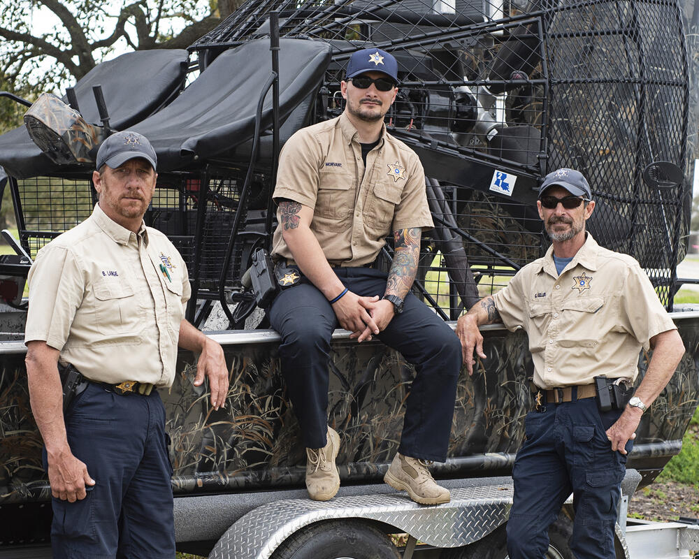 officers sitting on airboat