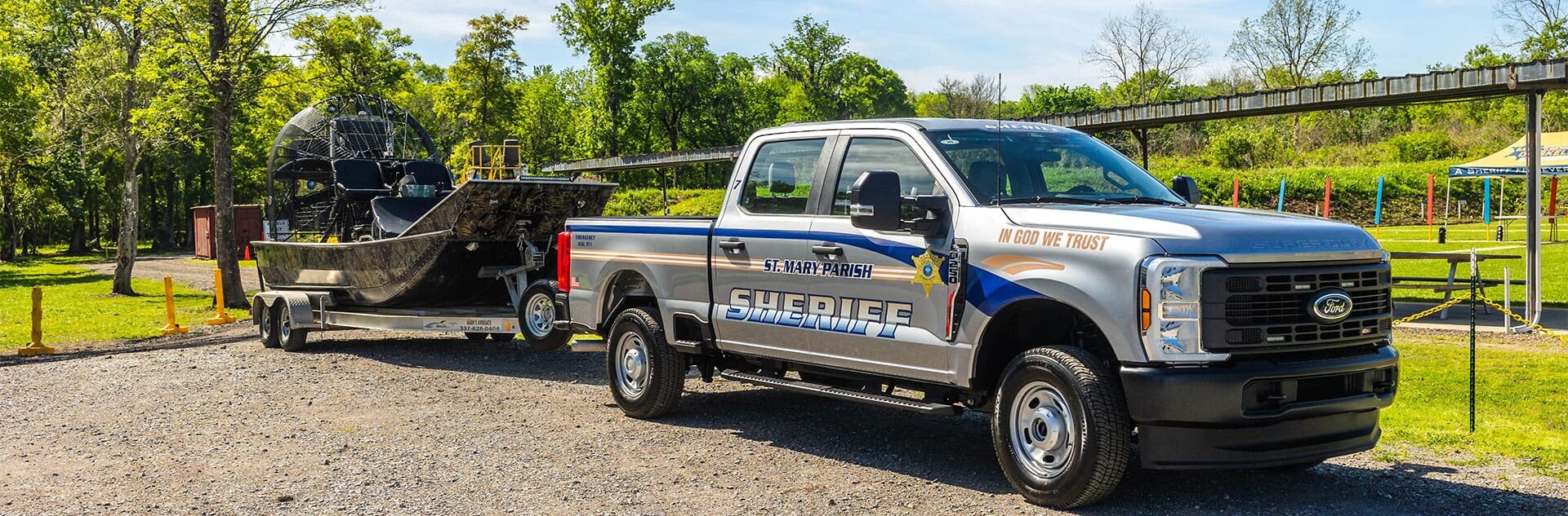 Sheriff Office truck hauling a trailer with airboat.