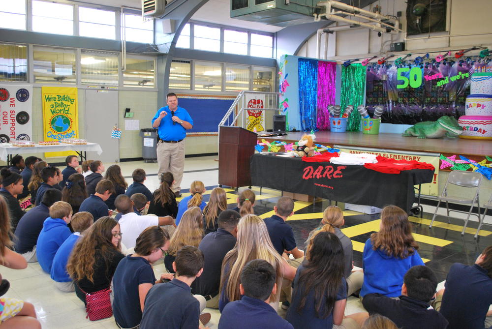 Man speaking to group of young DARE students