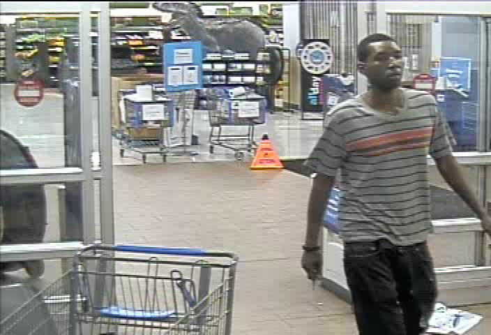 black male in striped v-neck tshirt and black jeans - suspect 1