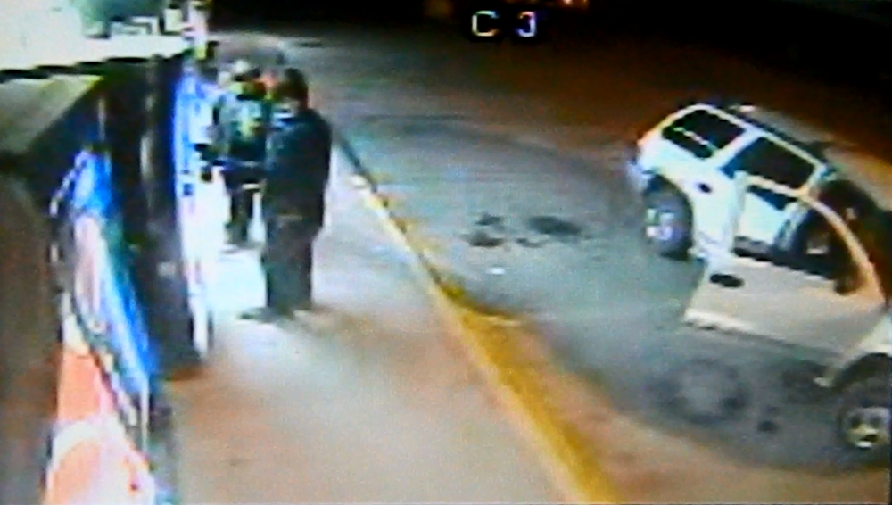 Suspects - two people standing in front of vending machine