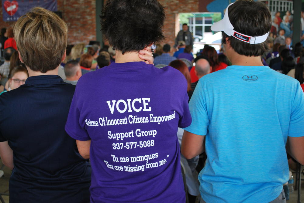 3 students standing with backs to the camera