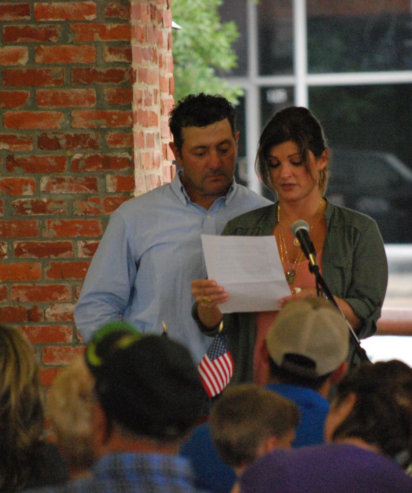 Guest Speakers - Breaux Family, reading off of a piece of paper